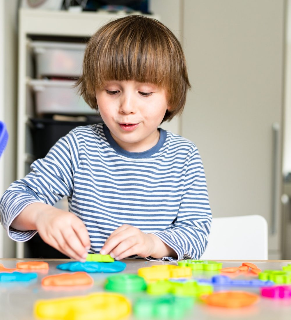 toddler-child-playing-with-modeling-compound-set-at-home-kid-early-development-creative-play-.jpg